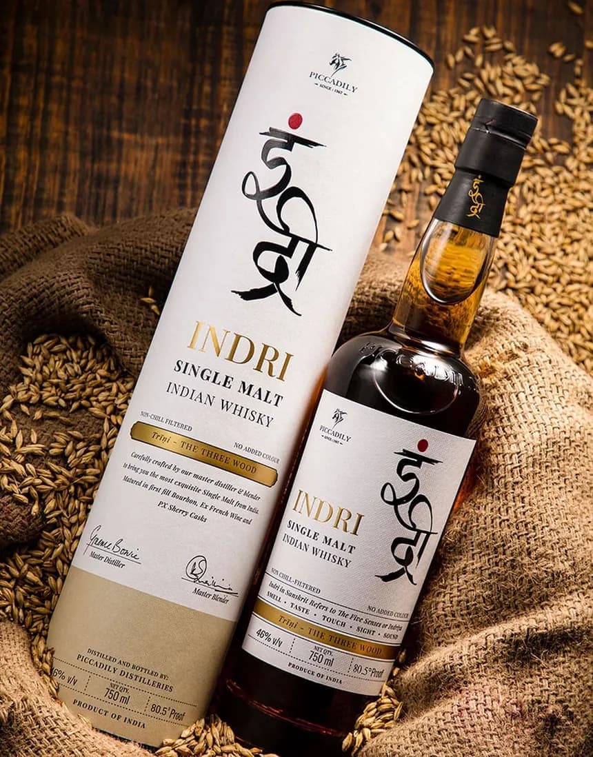 Indri bottle and tube resting on jute among hand-harvested barley grains